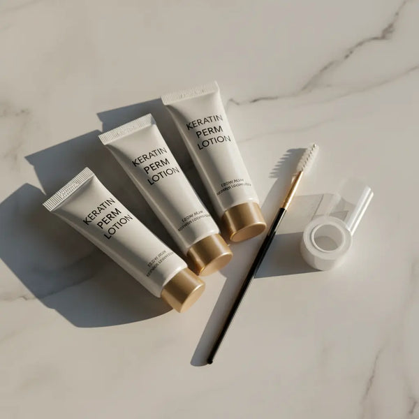 Three tubes of Keratin Perm Lotion on a marble surface