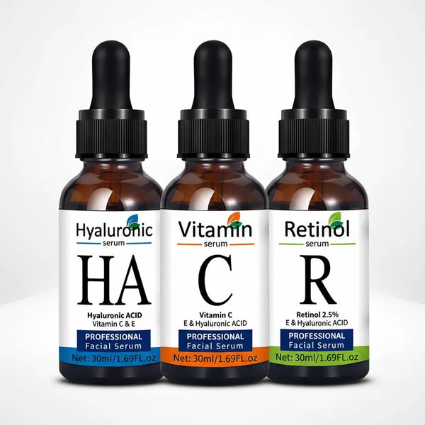 Set of three facial serums: Hyaluronic Acid, Vitamin C, and Retinol 2.5%, in amber glass dropper bottles.
